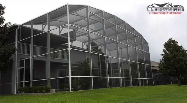 Two-story dome-style pool cage with white frame on a home in Lake Nona, FL